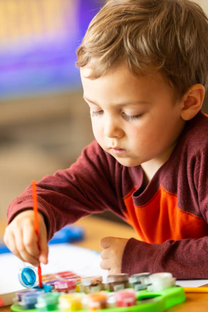 istock Three years old child painting with watercolors 1136688929