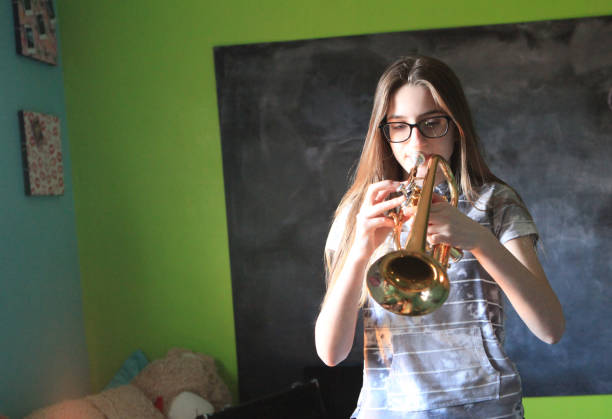 istock Teen girl practicing trumpet 1136689249