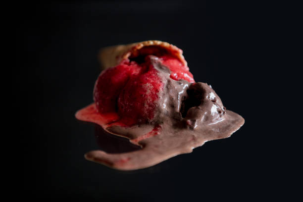 istock Melted chocolate and raspberry ice cream on glass 1136692661