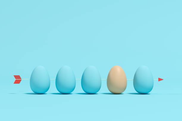 istock An Egg among blue eggs with arrow on blue background. Minimal Easter Idea concept. 1136693858