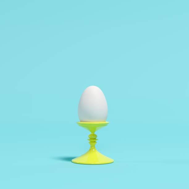 istock White egg on yellow dish on blue background. minimal idea concept. 1136693859