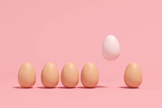 istock Outstanding white Egg Floating among brown eggs on pink background. minimal Easter idea. 1136693863