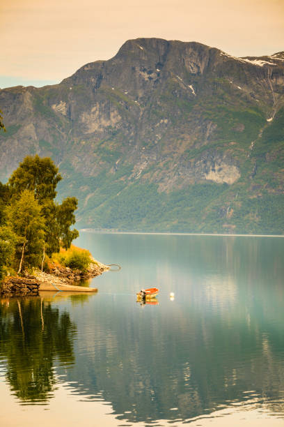 istock Little boat on water, norway fjord 1136694113