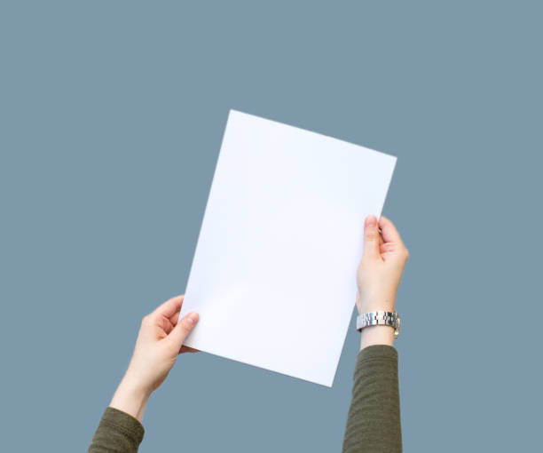 istock Female hands holding blank white paper 1136695850