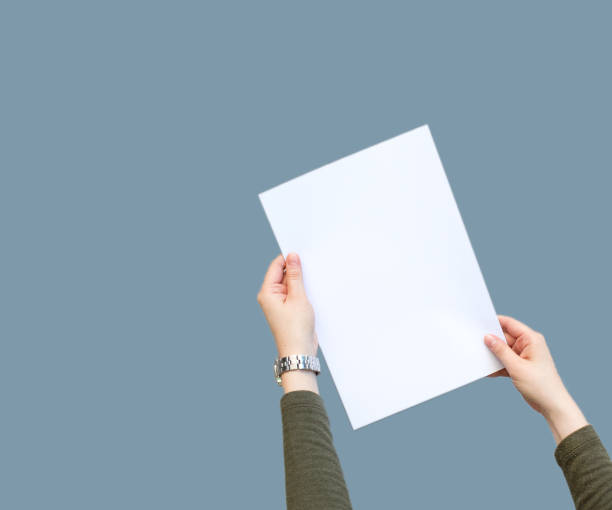 istock Female hands holding blank white paper 1136695851