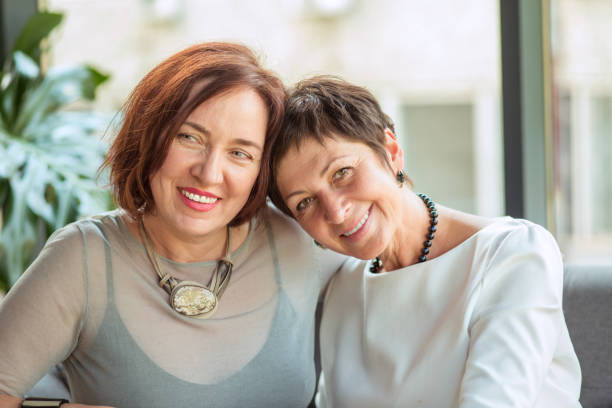 istock Middle-aged trendy women sitting in cafe 1136695905