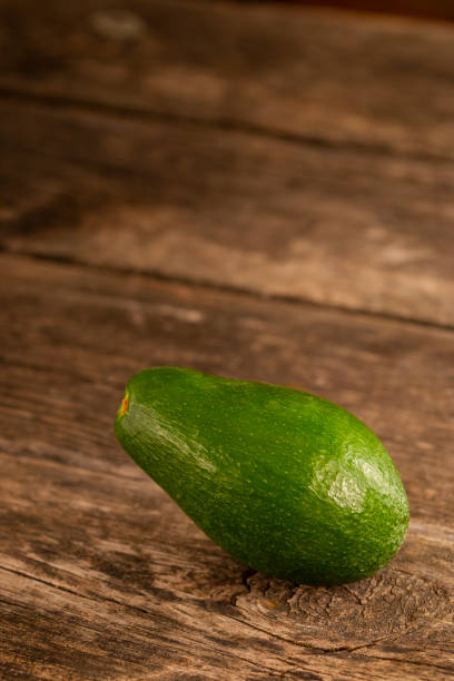 istock Shiny green avocado on wood 1136696000