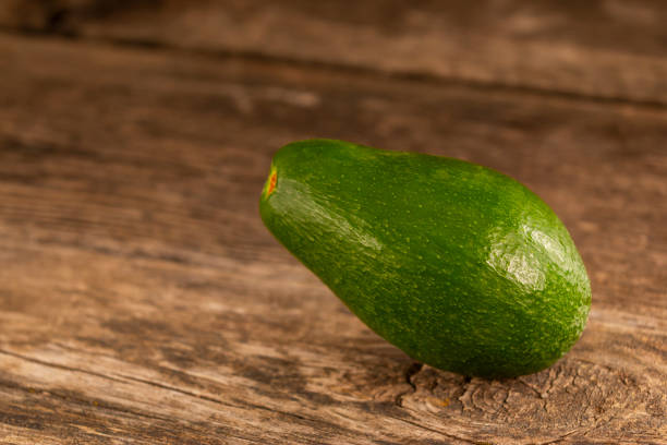 istock Shiny green avocado on wood 1136696003