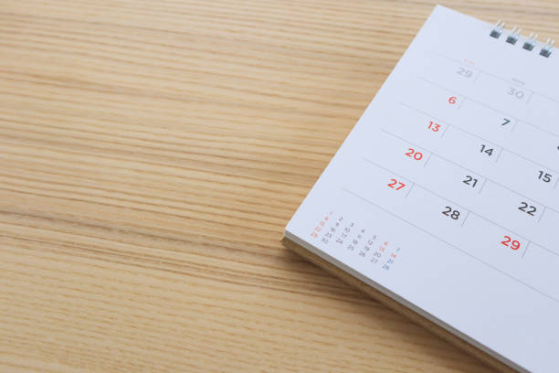 istock calendar page on wood table background 1136699620