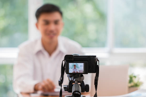 istock Happy Asian businessman videoblog / blogger vlogger recording online course or tutorial strategy presentation pass video for teaching live marketing sharing social media channel by mirrorless camera 1136700980