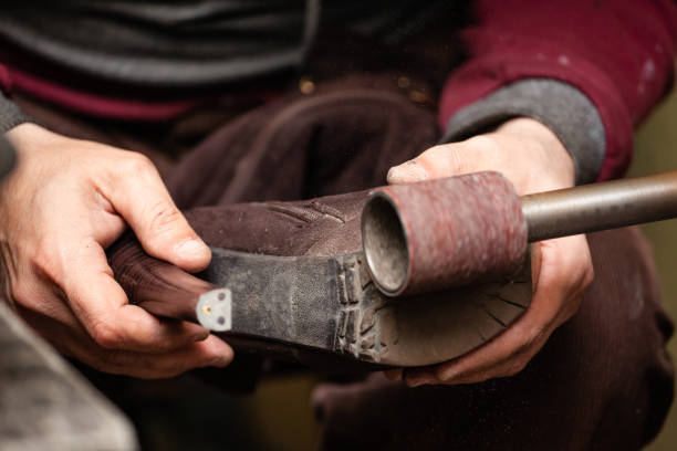 istock close-up of male shoemaker hands sanding a sole on a machine tool 1136705738