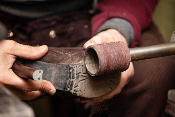 istock close-up of male shoemaker hands sanding a sole on a machine tool 1136705752