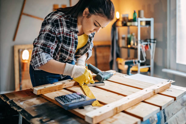 istock Woman measuring wooden piece 1136705879