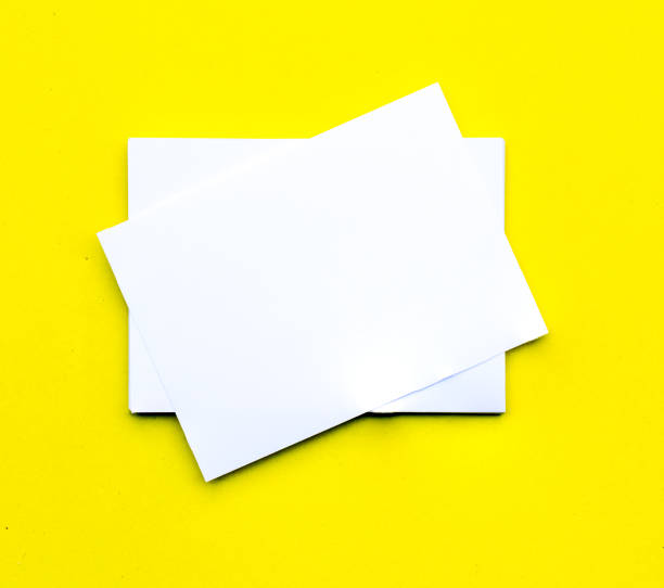 istock Blank business cards on yellow background 1136709881