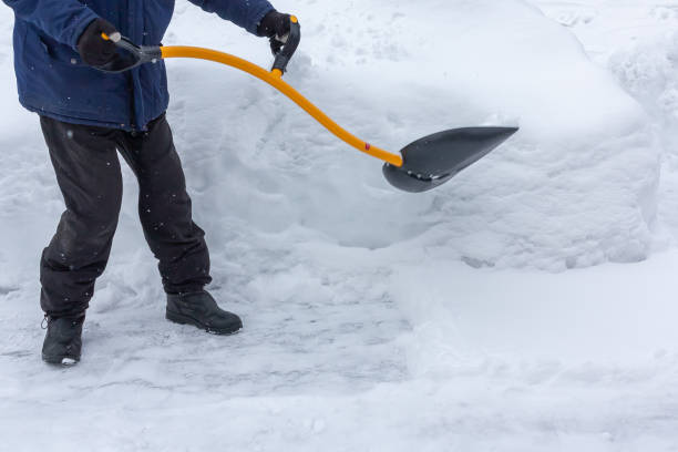 istock A man cleans snow in the yard with a shovel after a heavy snowfall 1136717245