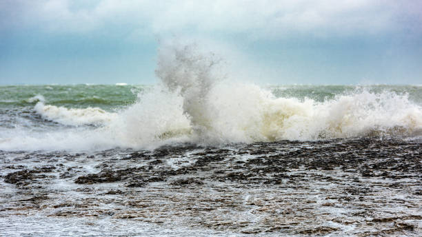istock Splash of huge waves on a rocky shore 1136728817