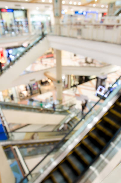 istock blur of interior department store with escalator movement 1136729198