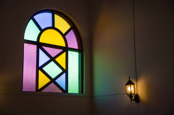 istock colorful glass window with lamp light on wall 1136729232