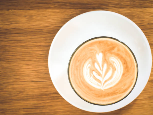 istock hot milk coffee on white glass plate wooden table background 1136730491