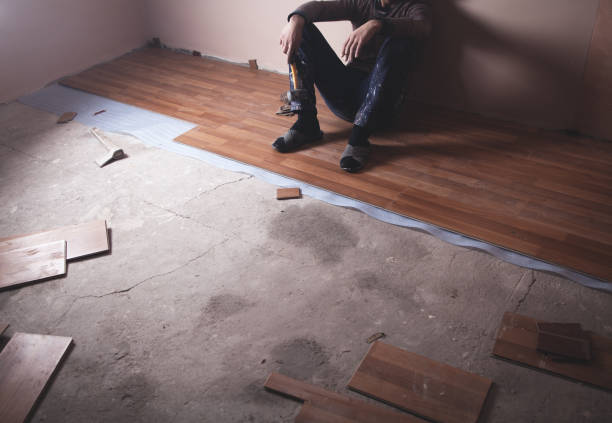 istock Worker installing new laminate wooden floor. 1136731536