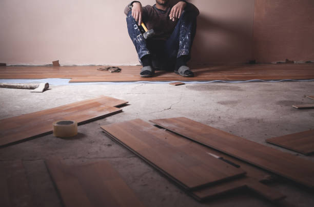 istock Worker installing new laminate wooden floor. 1136731539