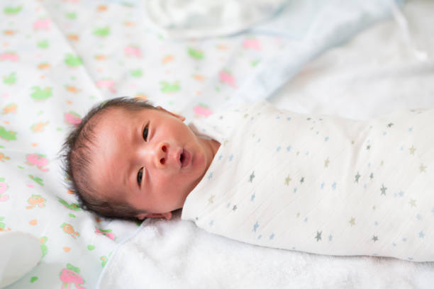 Asian newborn baby was wrapped in cloth after bathing, Ten days old Asian newborn baby was wrapped in cloth after bathing, Ten days old wrap dress stock pictures, royalty-free photos & images