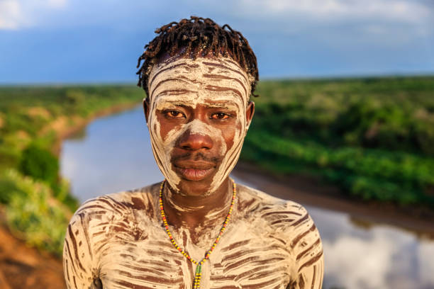 Portrait of young African man from Karo tribe, East Africa The Karo tribe is a tribe that lives in the southwestern region of the Omo Valley near Kenya, Africa. They are largely pastoralists. omo river photos stock pictures, royalty-free photos & images