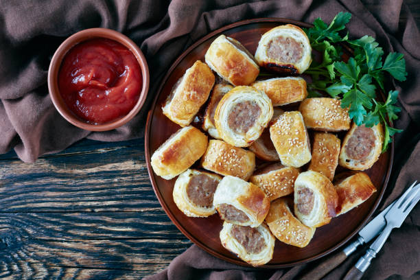 istock freshly baked Puff pastry Sausage rolls, top view 1136745810