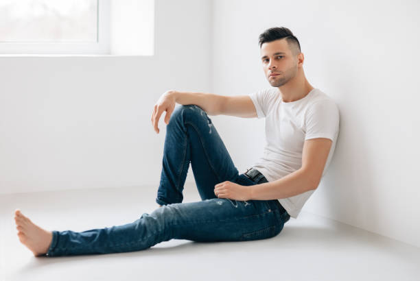istock Thoughtful handsome man portrait sitting on floor 1136746558