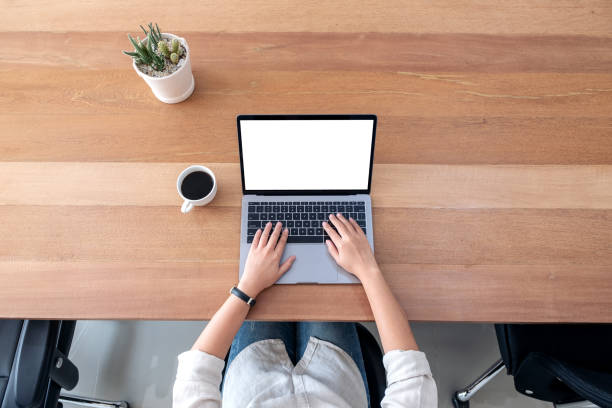 istock a woman using and typing on laptop with blank white desktop screen 1136747999
