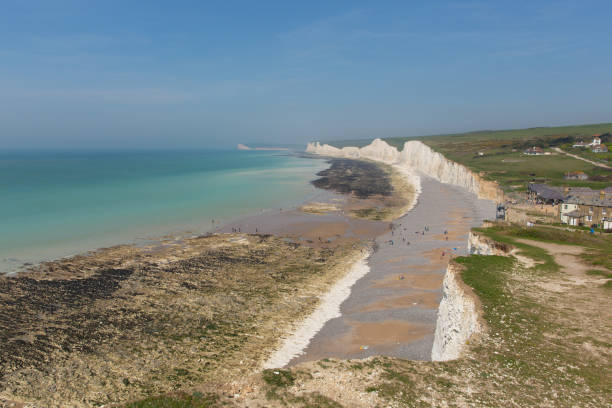 istock Birling gap beach and Seven Sisters white chalk cliffs England UK with tide out 1136750086