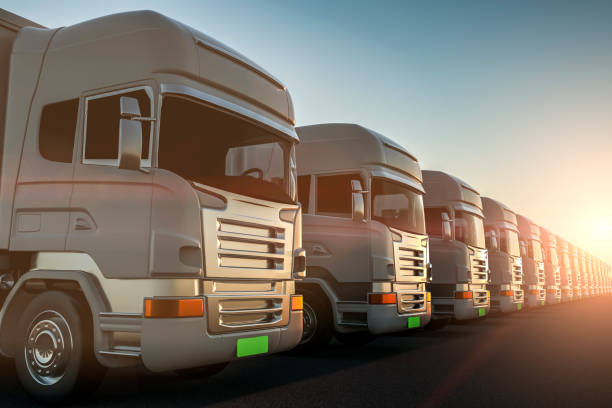 istock Row of cargo electric trucks against with sun 1136751132