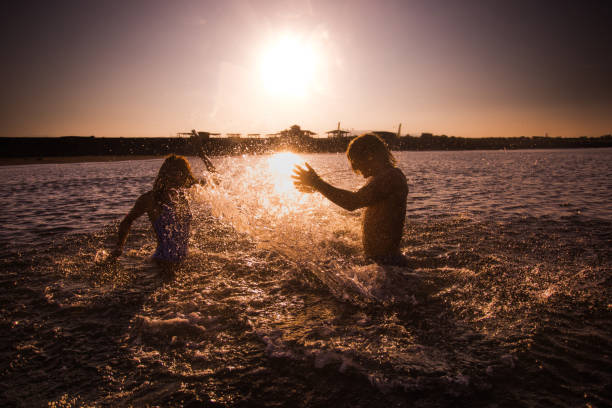 istock Splashing in the sea at sunrise! 1136751723