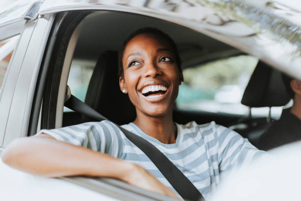 Happy woman driving a car stock photo