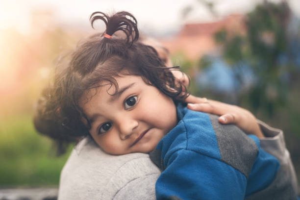istock Mother hugging little daughter portrait 1136752690