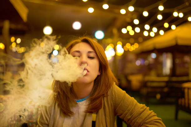 istock Young woman smoking hookah 1136752876