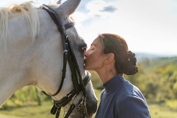 istock She's kissing her horse with affection 1136753671