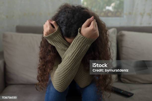 Unhappy Girl On Sofa Stock Photo - Download Image Now - Teenager, Terrified, Sadness