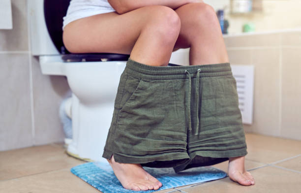 When nature calls Closeup shot of a woman sitting on a toilet in a bathroom urinary tract infection stock pictures, royalty-free photos & images