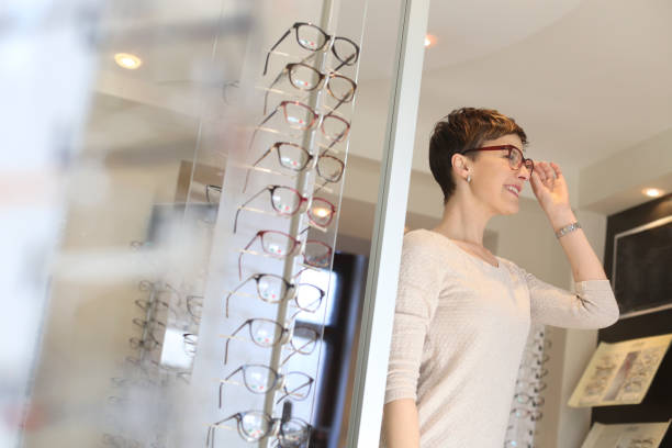 istock Young woman trying on new eyeglasses 1136760172