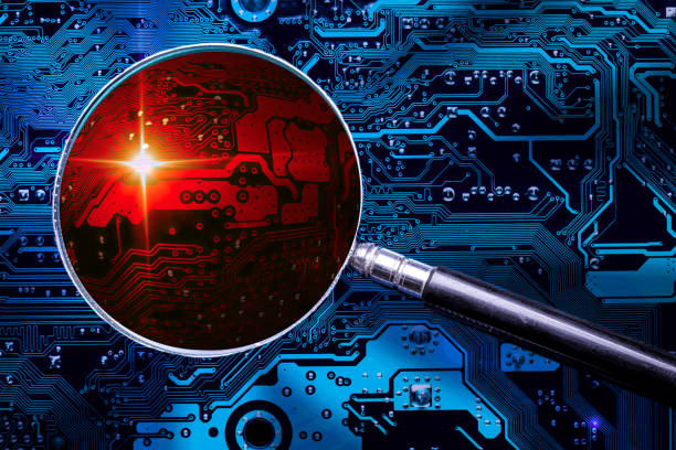 Blue circuit board background of computer motherboard and magnifier glass with red zoomed virus zone. Investigation for cybersecurity. stock photo