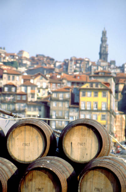 Port wine barrels on a boat on River Douro Port wine barrels on a boat on River Douro with Vila Nova de Gaia in the background, Porto, Portugal vila nova de gaia stock pictures, royalty-free photos & images