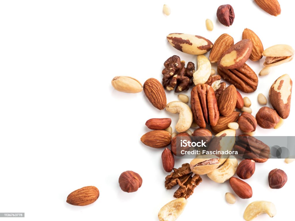 cashew, pecan, pine nuts, hazelnut isolated Background of nuts - pecan, macadamia, brazil nut, walnut, almonds, hazelnuts, pistachios, cashews, peanuts, pine nuts.Copy space. Isolated one edge on white with clipping path. Top view or flat lay Nut - Food Stock Photo