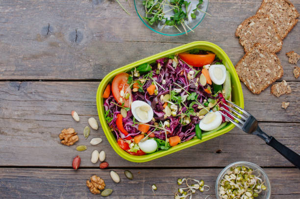 istock Lunch box with vegetable salad on rustic wooden background 1136764909