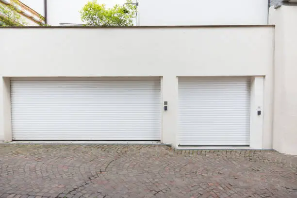 Closed metal glass exits garage fronts / facade in Germany / Europe.