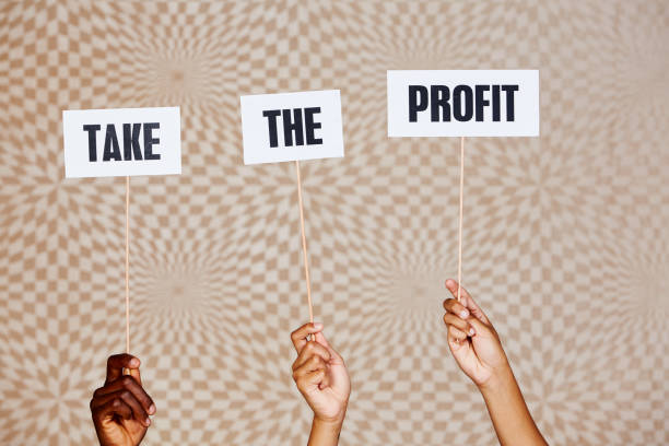 istock Three raised hands with signs reading 