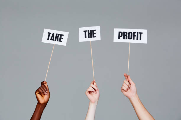 istock Three raised hands with signs reading 