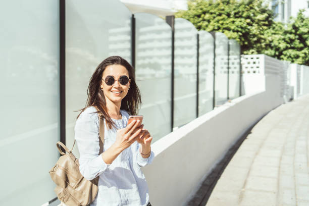 istock Pretty brunette girl outdoor  using smart phone. 1136769649