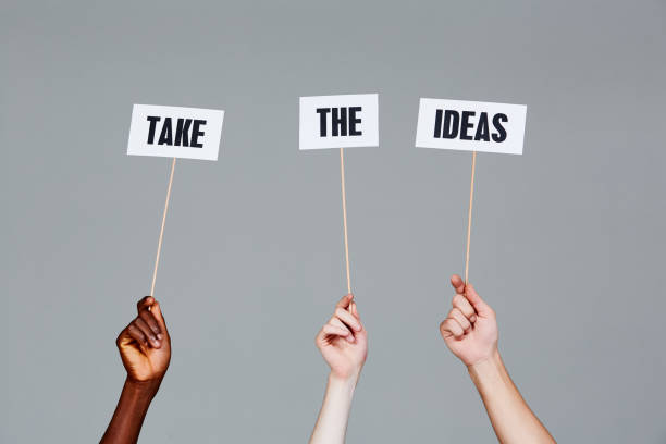 istock Three hands on gray with signs reading 