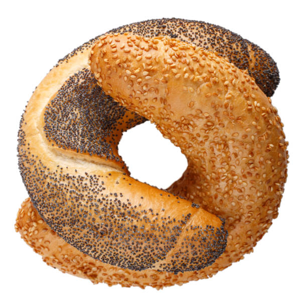 istock Two crescent rolled buns with sesame and poppy seeds isolated on white background. Freshly baked bagels close-up. 1136770098